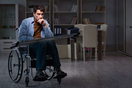 Man suffering from depression at wheelchairの写真素材