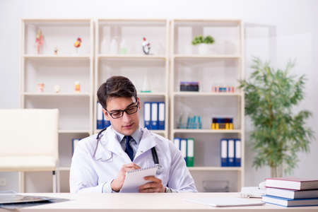 Young doctor sitting in the officeの写真素材