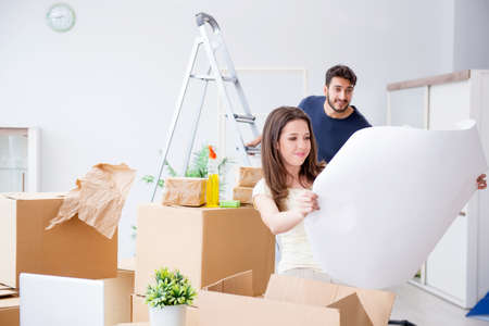 Young family unpacking at new house with boxes