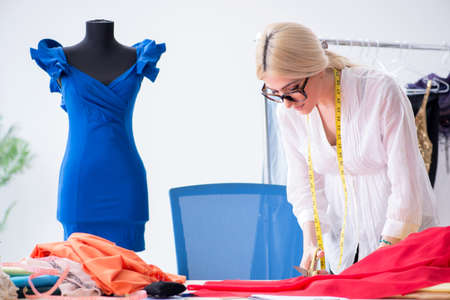 Woman tailor working on new dress designsの写真素材