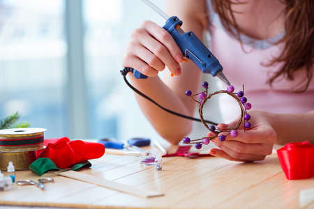 Woman making jewelry at homeの写真素材