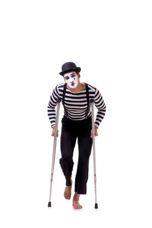 Mime with crutches isolated on white backgroundの写真素材
