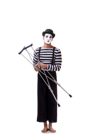 Mime with crutches isolated on white backgroundの写真素材