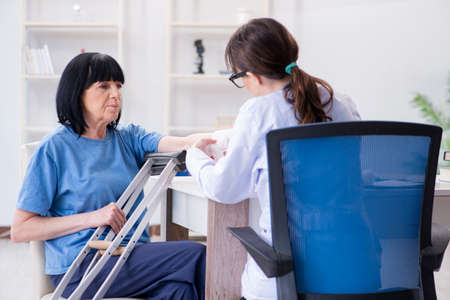 Doctor examining old mature woman after incidentの写真素材