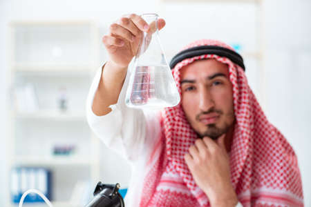 Arab chemist checking the quality of drinking waterの写真素材