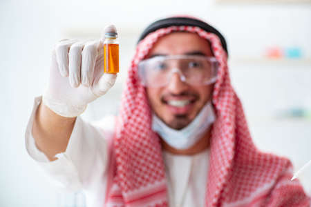 Arab chemist working in the lab officeの写真素材