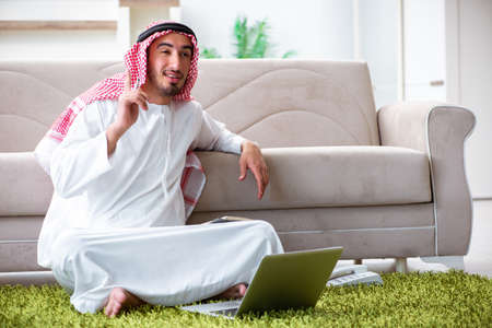 Arab man working at home on his workの写真素材