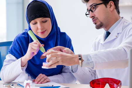 Dentist doctor and assistant working on new tooth implantの写真素材