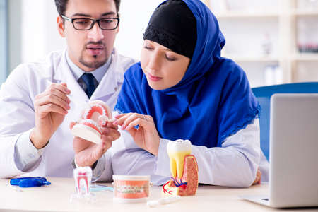 Dentist doctor and assistant working on new tooth implant