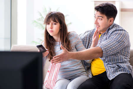 Pair watching tv at homeの写真素材