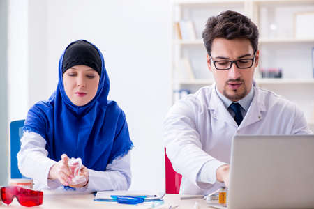 Dentist doctor and assistant working on new tooth implantの写真素材