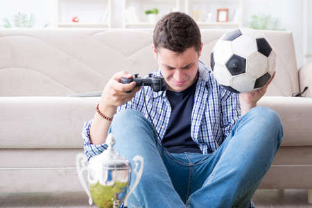Young man playing computer games at homeの写真素材