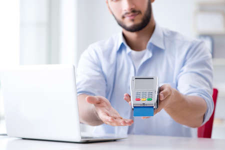 Man processing credit card transaction with POS terminal