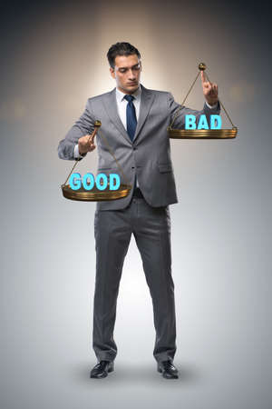 Businessman choosing between good and badの写真素材
