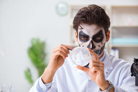 Scary monster doctor working in labの写真素材