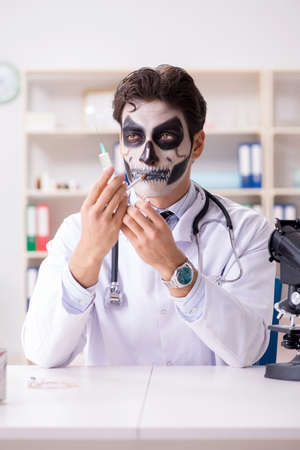 Scary monster doctor working in labの写真素材