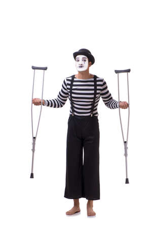 Mime with crutches isolated on white backgroundの写真素材