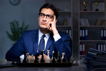 Businessman playing chess in strategy conceptの写真素材