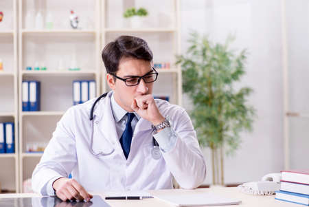 Young doctor sitting in the officeの写真素材