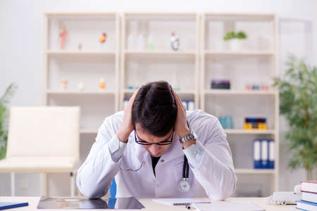 Young doctor sitting in the officeの写真素材