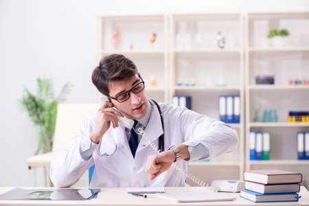 Young doctor sitting in the officeの写真素材