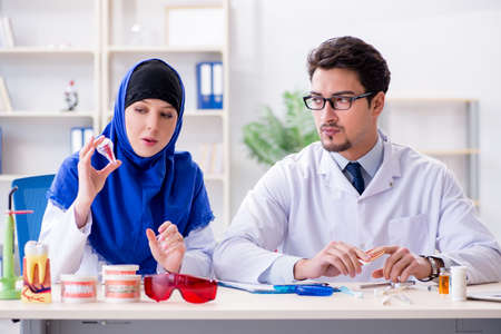 Dentist doctor and assistant working on new tooth implantの写真素材