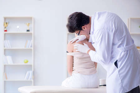 Doctor examining the skin of female patientの写真素材
