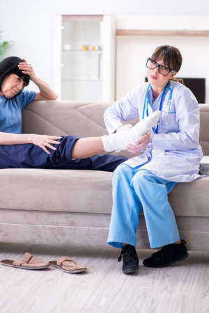 Doctor examining old mature woman after incidentの写真素材