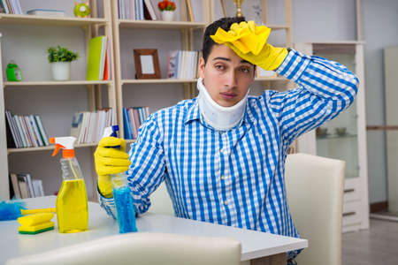 Man with neck unjury cleaning house in housekeeping concept