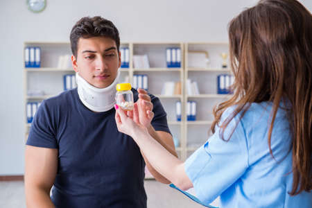 Man with neck injury visiting doctor for check-upの写真素材