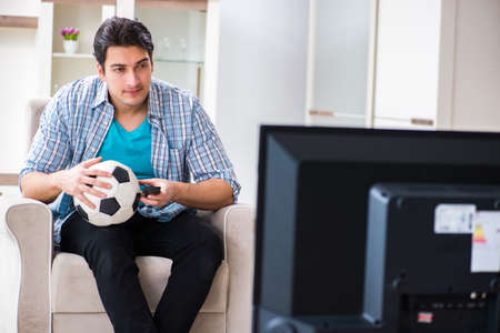 Man watching tv at homeの写真素材