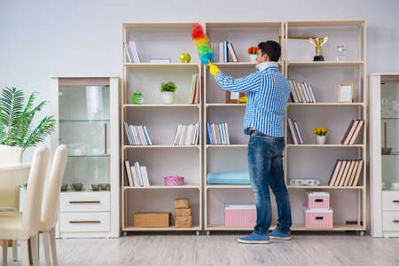 Man with neck unjury cleaning house in housekeeping concept