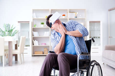 Disabled man studying with virtual reality glassesの写真素材