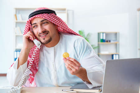 Arab man with bitcoin in cryptocurrency mining conceptの写真素材