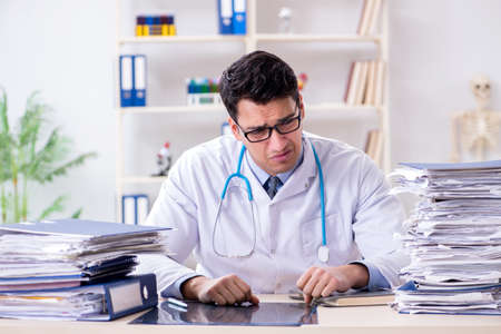 Busy doctor with too much work in hospitalの写真素材
