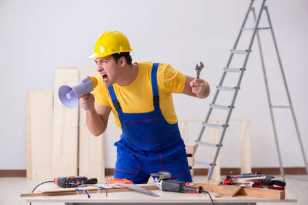 Floor repairman disappointed with his workの写真素材