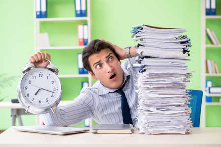 Businessman having problems with paperwork and workloadの写真素材