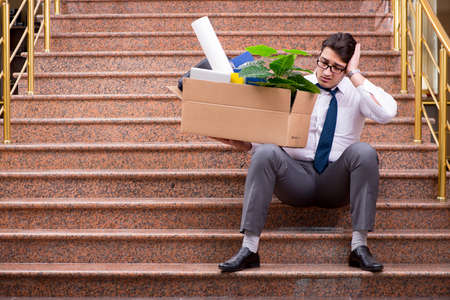 Young businessman on the street after dismissalの写真素材
