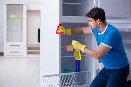 Man cleaning fridge in hygiene conceptの写真素材