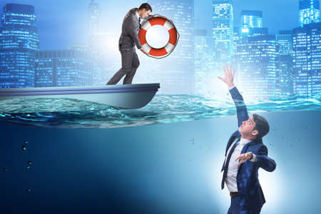 Businessman being saved from drowningの写真素材