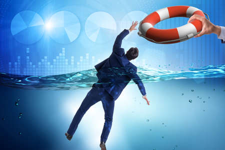 Businessman being saved from drowningの写真素材