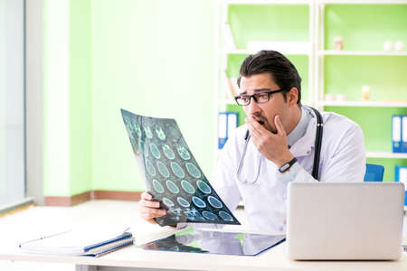 Doctor radiologist looking at x-ray scan in hospital