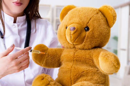 Child checking soft toy healthの写真素材