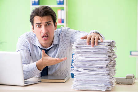 Businessman having problems with paperwork and workload