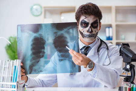 Scary monster doctor working in labの写真素材