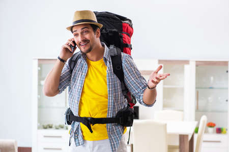 Backpacker packing for his tripの写真素材