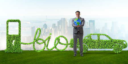 Businessman with car powered with biofuelの写真素材