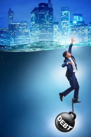 Businessman drowning in concept of high debtの写真素材