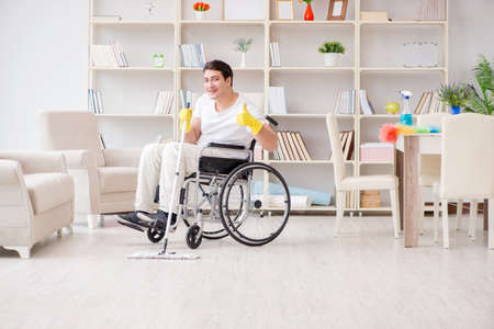 Disabled man cleaning floor at homeの写真素材