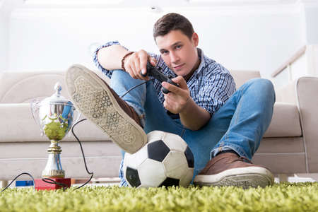 Young man playing computer games at home